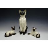 Three Royal Doulton Siamese cat figures, tallest 35 cm
