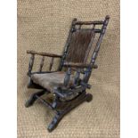 A Victorian child's American rocking chair, typical turned construction, seat supported on a base by