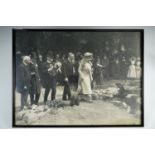 A framed large period photograph of a Royal visit from King George V and Queen Mary, in slender