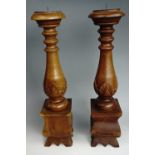 Two large Baroque influenced carved hardwood pricket candle sticks, 66 cm