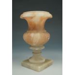 A small turned alabaster campana form vase