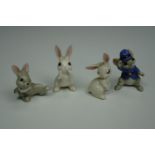 Three miniature novelty ceramic Whimsie-like figurines modelled as comical rabbits, together with