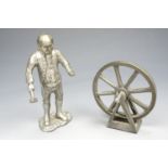 A pewter figure of a wheel-wright together with a pewter wheel, tallest 10 cm
