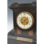 An early 20th Century marble and polished black slate architectural mantel clock, bearing a brass