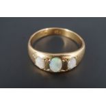 An antique opal and 18 ct yellow metal ring, comprising three oval cabochons, the largest 5 mm x 3