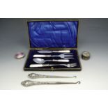 A cased silver and mother of pearl table set, consisting of butter knife, jam spoon, and two