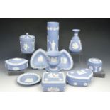 Twelve items of Wedgwood blue Jasperware including four lidded boxes, three vases etc