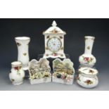 A Royal Albert 'Old Country Roses' clock together with three matching vases, a pot and two Royal