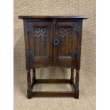 A diminutive Gothic influenced oak side cabinet or bedside cabinet, 68 cm