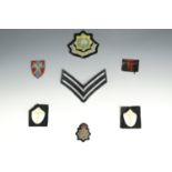 A small group of military and other cloth insignia including a pair of slip-on 8th Army shoulder