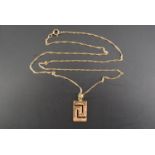 A yellow metal Greek key pendant and neck chain, 16 mm x 10 mm, 2.4 g