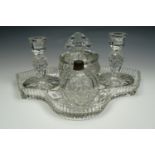 A five piece glass dressing table set