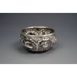 An Indian / Asian white metal salt cellar, repousse worked, punched and engraved in depiction of