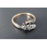 A vintage twist-set three-stone diamond engagement ring, the stones platinum illusion set on 9 ct