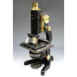 A cased Watson "Service" monocular microscope, having a micrometer stage, circa 1930s