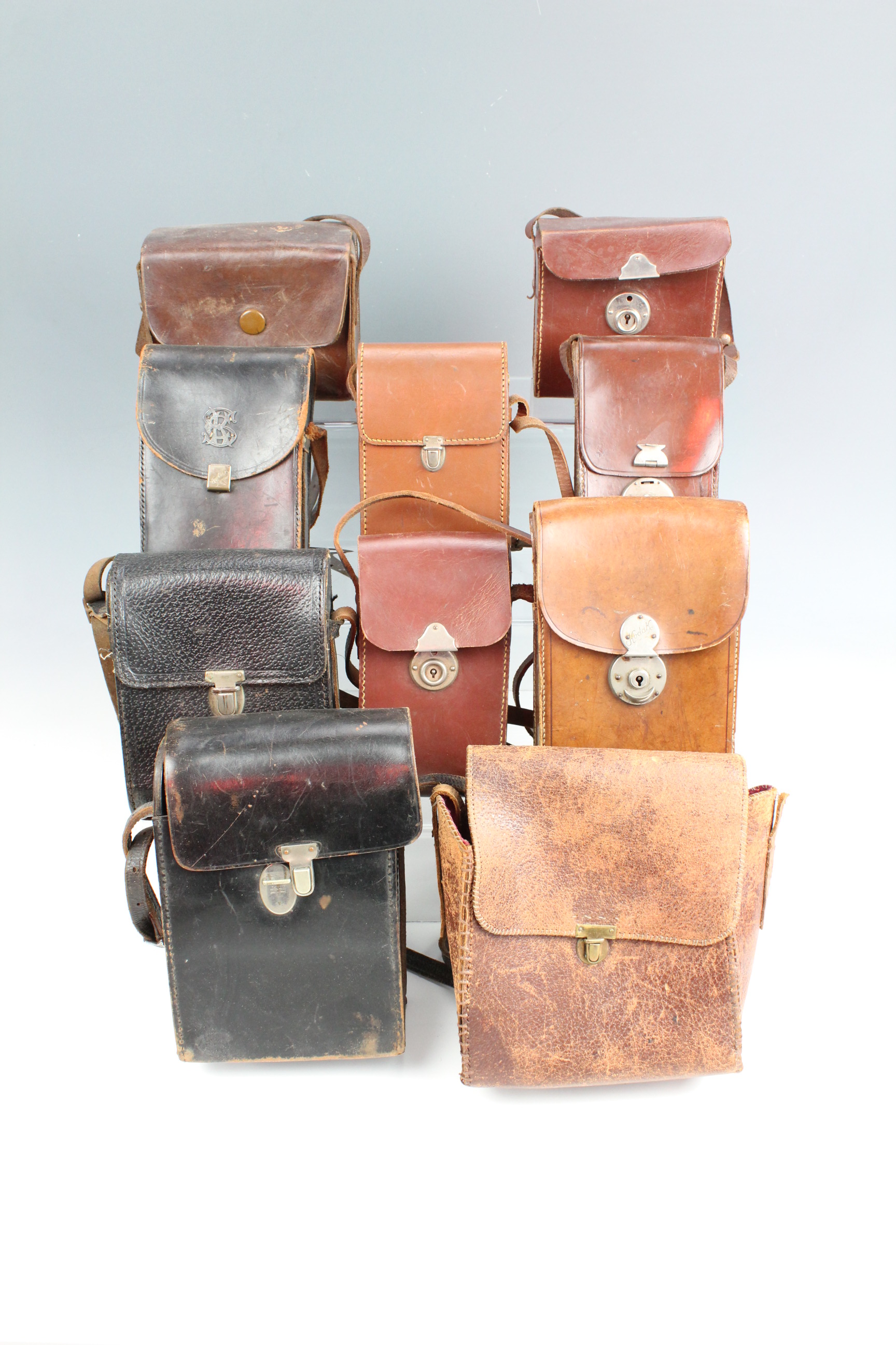 A quantity of vintage leather camera cases