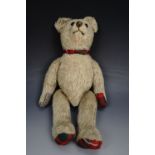 An early 20th Century plush Teddy bear, of articulated construction, with growler mechanism, 34 cm