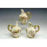 Three Royal Worcester blush ivory jugs, comprising a pair with floral decorated bodies and a third