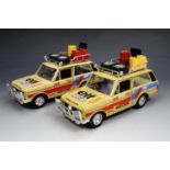 A pair of die-cast Range Rover off road vehicles