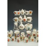 A large quantity of W.H. Goss crested china tygs, together with similar crested miniatures,