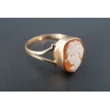 A 9 ct gold mounted shell cameo ring, the cameo bezel set between bifurcated shoulders, N/O, 1.4 g