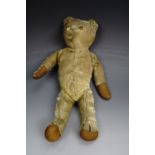 An early 20th Century golden plush and articulated wood wool filled Teddy bear, having an internal