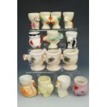 Fourteen various vintage novelty egg cups in the form of animals