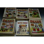 A carton of Beano comics and a related book