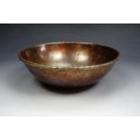 A Keswick School of Industrial Art planished copper circular bowl, having a cabled turned rim, 20 cm