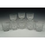 A set of eight fine cut glass whisky tumblers, decorated with grape and vine engraving over comb cut
