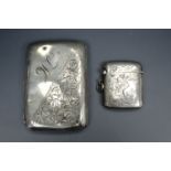 An early 20th Century silver Vesta case together with a silver cigarette case, 97 g