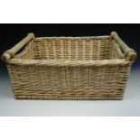 A small wicker log or similar basket, 50 x 40 x 20 cm