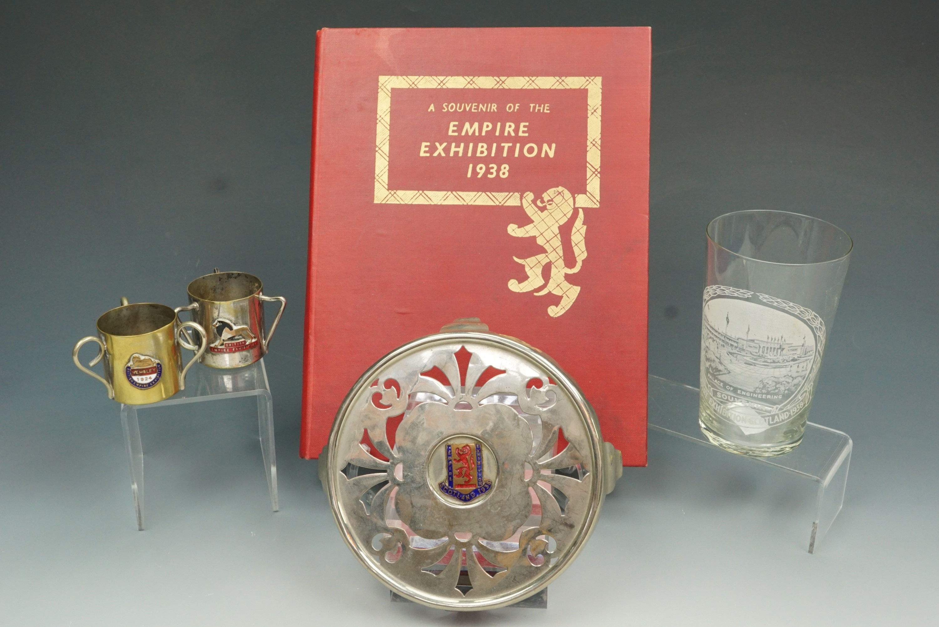 A group of 'Empire Exhibition 1938' commemoratives comprising of a book, an enameled whiskey