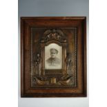 World War I memorial photograph frame, bronzed plaster with soldiers flanking a photograph of a