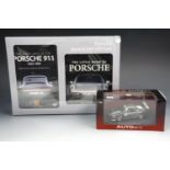 An AUTOart Porsche 911 die-cast model car together with a as new in box Porsche book & DVD gift set