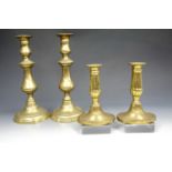A pair of Georgian influenced brass candle sticks together with a pair of Victorian brass