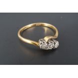 A vintage twist-set three-stone diamond engagement ring, the brilliants platinum illusion set on