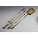 Three piece brass fireside companion set, poker 69 cm long.