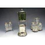 An Arts & Crafts pewter and green glass jar together with two cruet sets and an electroplate