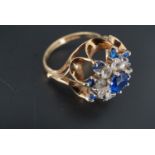 A 1970s flamboyant blue and white stone dress ring, the gems claw set in a radiating arrangement