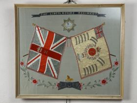 A late 19th / early 20th Century Lincolnshire Regiment silk-work picture, framed under glass, 55