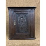 A small carved oak corner cupboard, 48 cm x 48 cm x 72.5 cm.