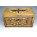 A late Victorian two compartment oak tea caddy