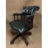 A late 20th Century green hide upholstered revolving desk chair