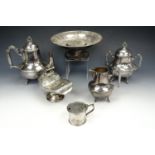A three piece electroplate tea set together with an electroplate sugar scuttle with hinged lid and