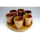 Set of six turned oak egg cups on a conforming turned base, made by Sweeney Bros., Donegal.