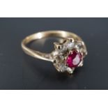 A 1960s ruby and white stone cluster ring, the ruby of approx 4 mm, set on 9 ct gold, P/Q, 1.9 g