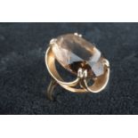 A cairngorm and 9 ct gold cocktail ring, the faceted smoky quartz of approx 20 mm x 15 mm claw set