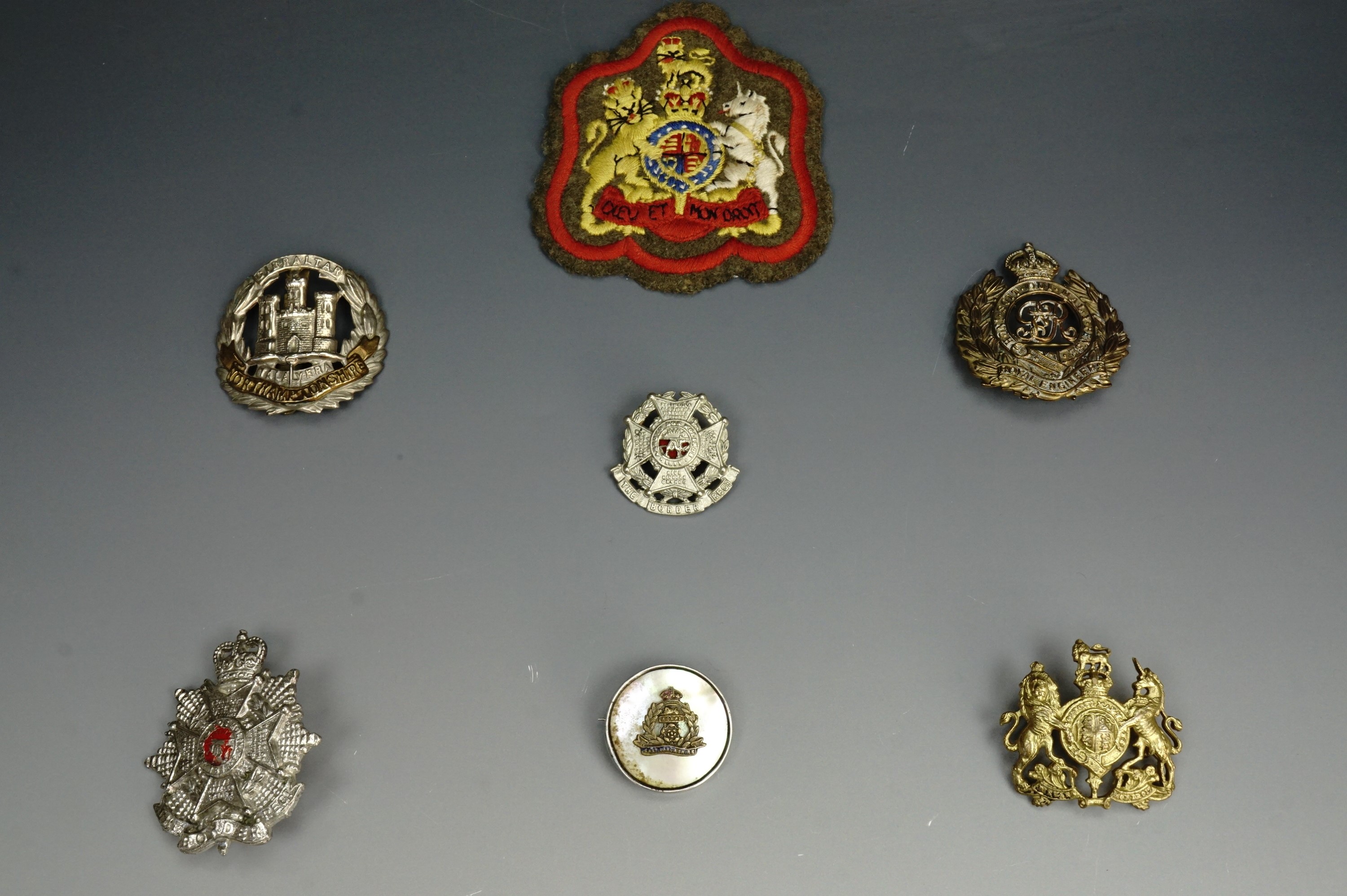 A small group of British army insignia including a Border Regiment cap badge of circa 1953-9