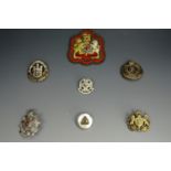 A small group of British army insignia including a Border Regiment cap badge of circa 1953-9